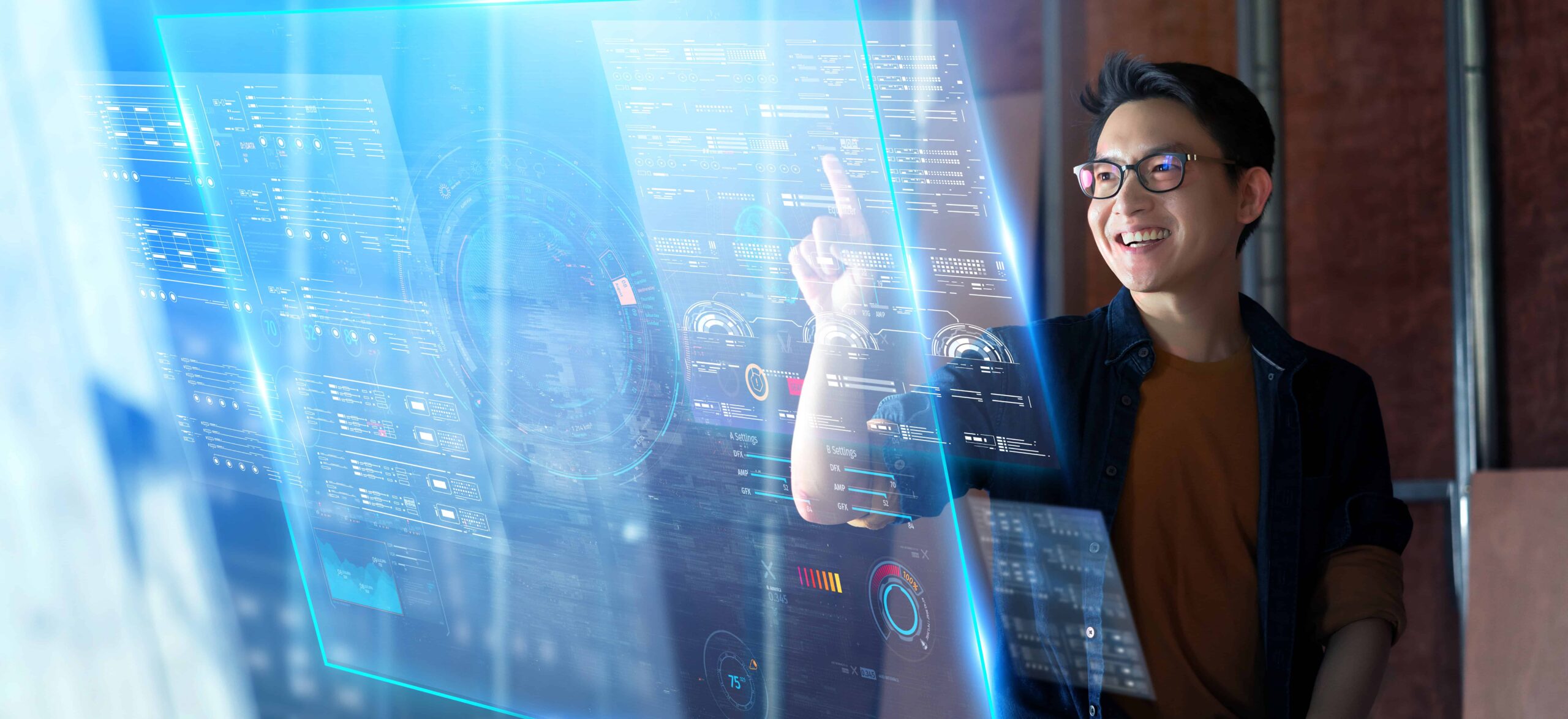 Young man using futuristic touchscreen interface with digital data visuals.