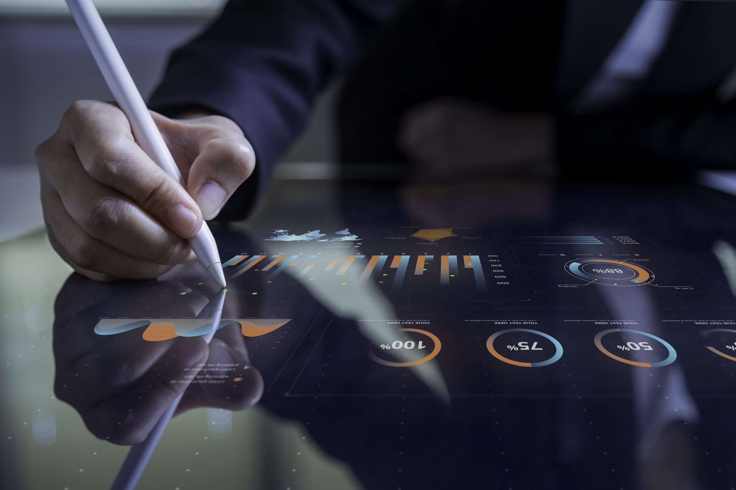 Business professional analyzing data on a digital tablet with a stylus.